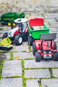 red and black ride on toy car on green grass