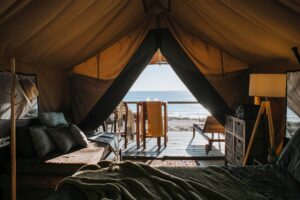 cozy tent with bed and terrace on beach