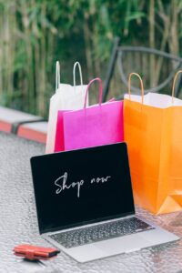 a laptop near paper bags
