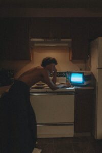 shirtless man watching television