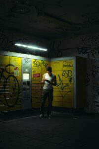 man standing on sidewalk near parcel locker