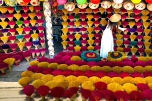 woman selling colorful traditional vietnamese incense sticks