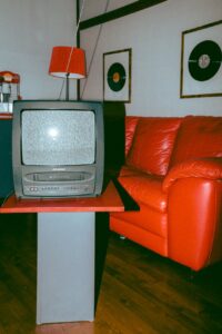 television beside s red couch