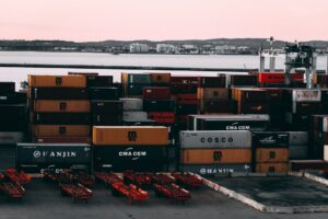 assorted color cargo containers near body of water