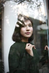 photo of woman wearing dark green sweater