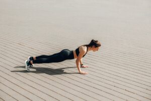 woman in black tank top and black leggings doing yoga