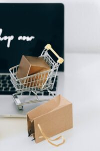 a miniature shopping cart on macbook laptop