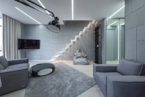 living room with sofas near table and tv with stairs