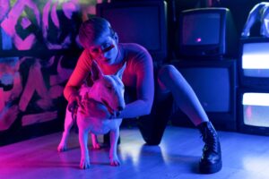 a man with a dog near televisions