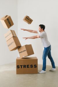 man falling carton boxes with negative words