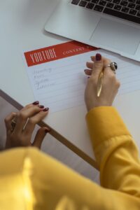 person in gold ring holding white paper