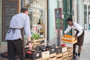 sellers putting fruit baskets in shop outdoors