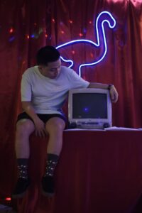 a man sitting beside the television