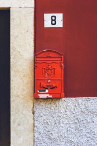 photo of red mailbox mounted on wall