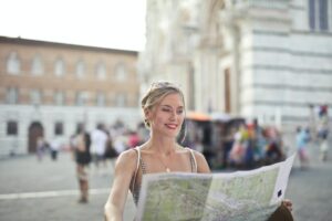 woman holding a map looking for next destination