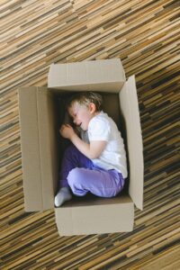 boy in white t shirt inside a box
