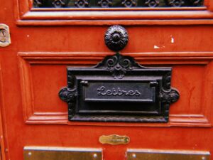 wooden door with metal letter box