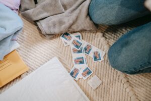 crop faceless person sitting on floor with postage stamps