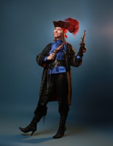 a woman in pirate costume holding a gun