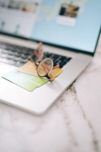 credit cards and eyeglasses on the laptop