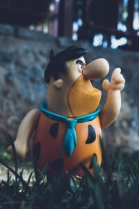 close up photo of a fred flintstones toy