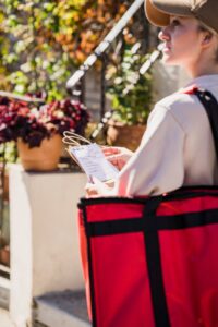 food delivery girl checking address of order recipient