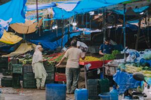 people near stalls at market