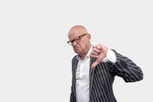 a man flashing the thumbs down sign