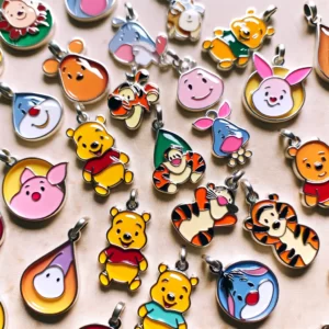 DALL·E 2024 02 19 06.56.06 A collection of 10 vibrant and beautifully crafted Disney Winnie the Pooh alloy drop oil charms. Each charm features a different character from the Wi 1