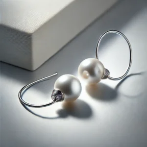 DALL·E 2024 10 14 19.50.59 A pair of elegant round pearl earrings with 925 silver needles displayed on a clean minimalistic background. The earrings have a simple classic de 1